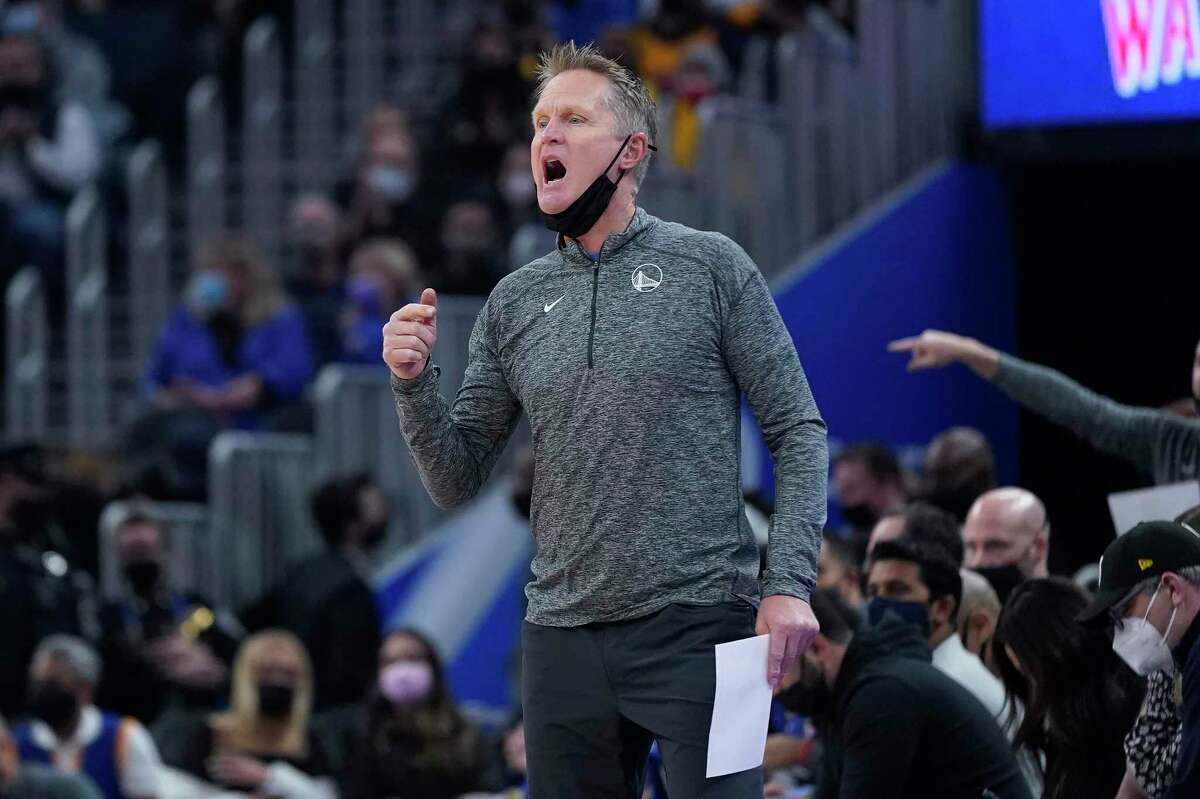 Golden State Warriors coach Steve Kerr reacts toward players during the first half of the team's NBA basketball game against the Denver Nuggets in San Francisco, Tuesday, Dec. 28, 2021. (AP Photo/Jeff Chiu)