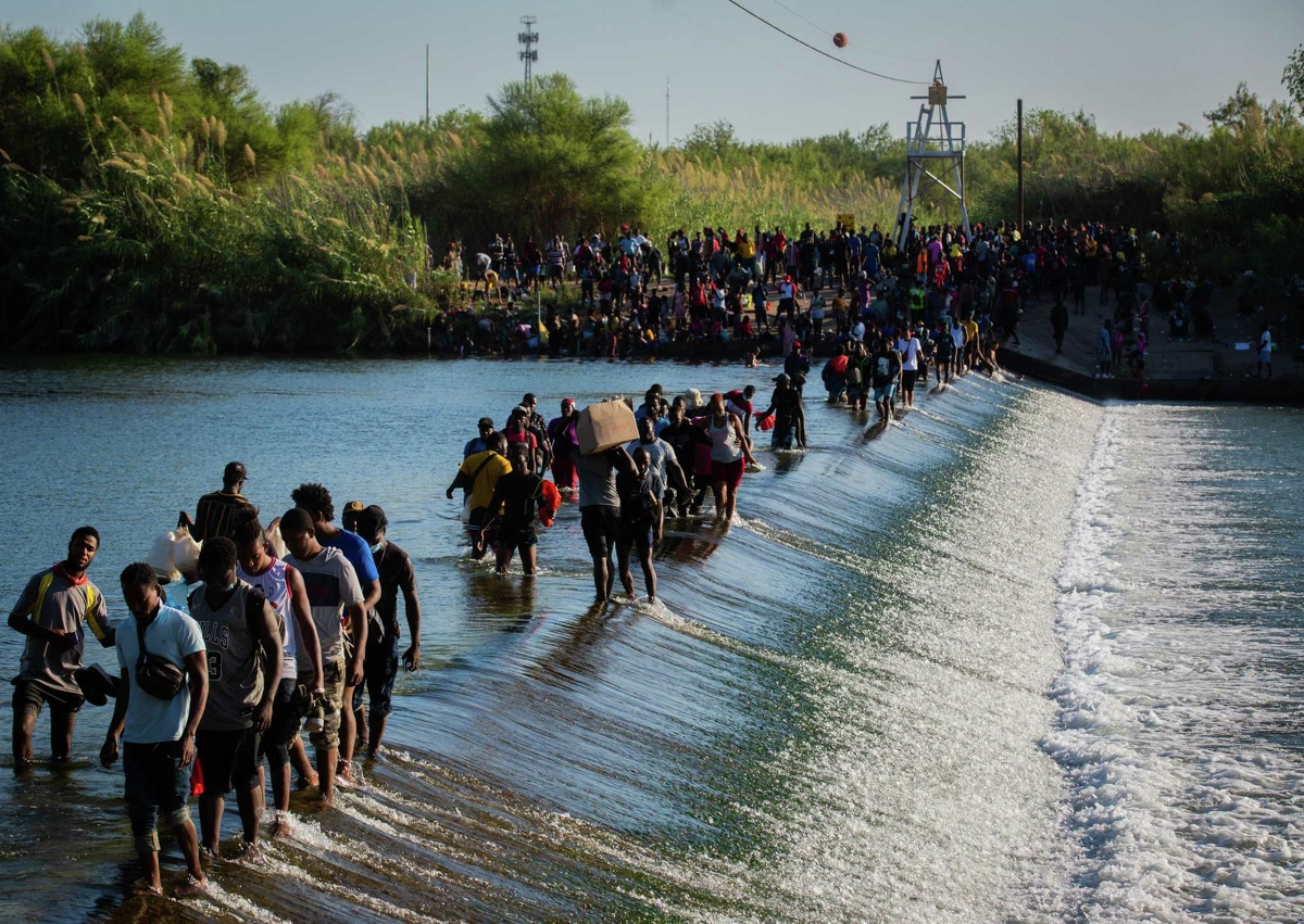 Migrants part of the group of people from Haiti waiting in Del Rio and Ciudad Acuña to get access to the United States cross the Rio Grande toward Ciudad Acuña to get supplies, Friday, Sept. 17, 2021, in Ciudad Acuña.