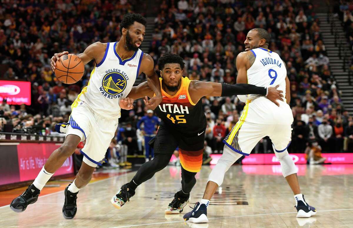 SALT LAKE CITY, UTAH - JANUARY 01: Andrew Wiggins #22 of the Golden State Warriors drives against Donovan Mitchell #45 of the Utah Jazz during the second half of a game at Vivint Smart Home Arena on January 01, 2022 in Salt Lake City, Utah. NOTE TO USER: User expressly acknowledges and agrees that, by downloading and or using this photograph, User is consenting to the terms and conditions of the Getty Images License Agreement. (Photo by Alex Goodlett/Getty Images)