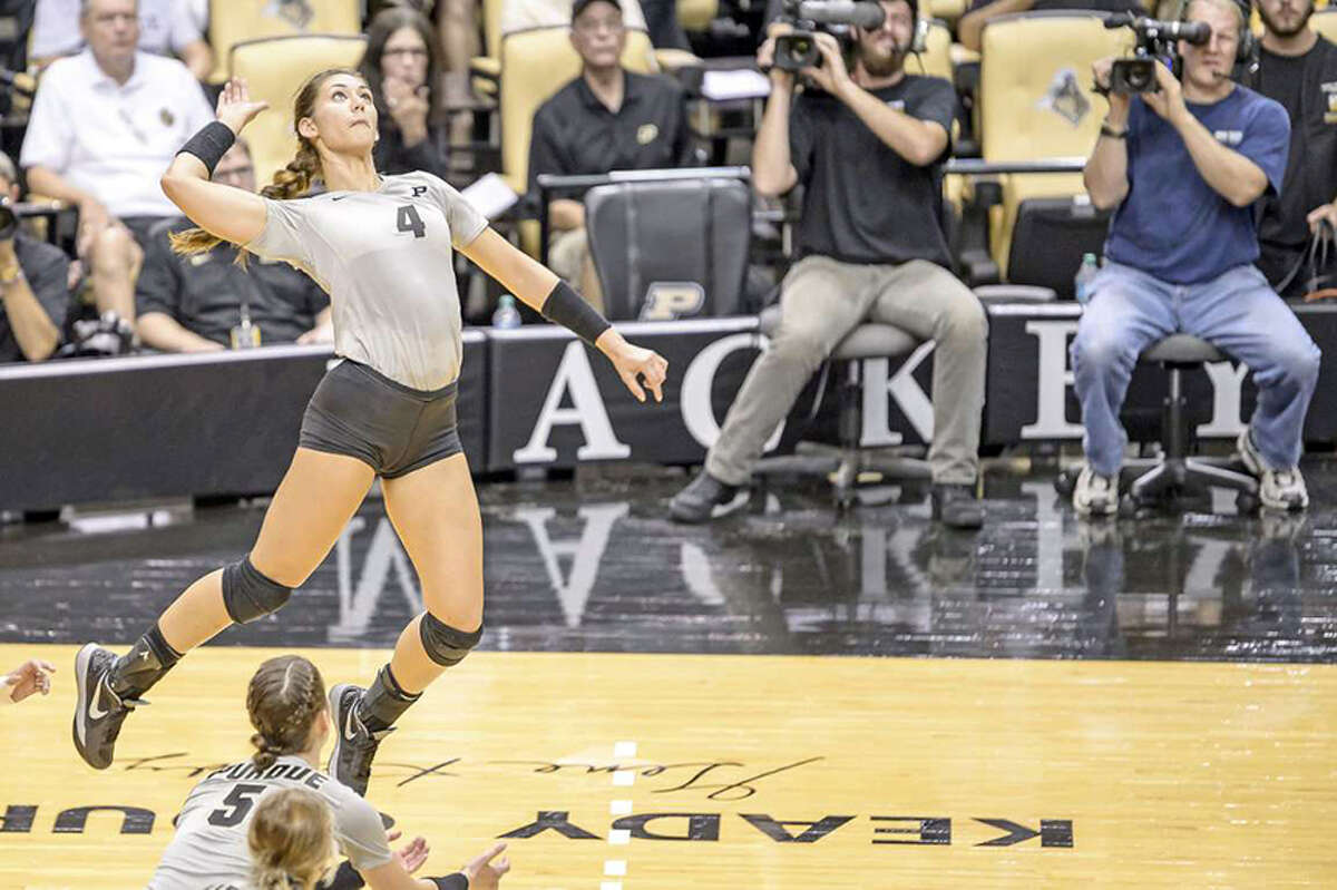 Sam Epenesa, a 2012 Edwardsville High School graduate, goes up for a kill during her volleyball playing days at Purdue University.