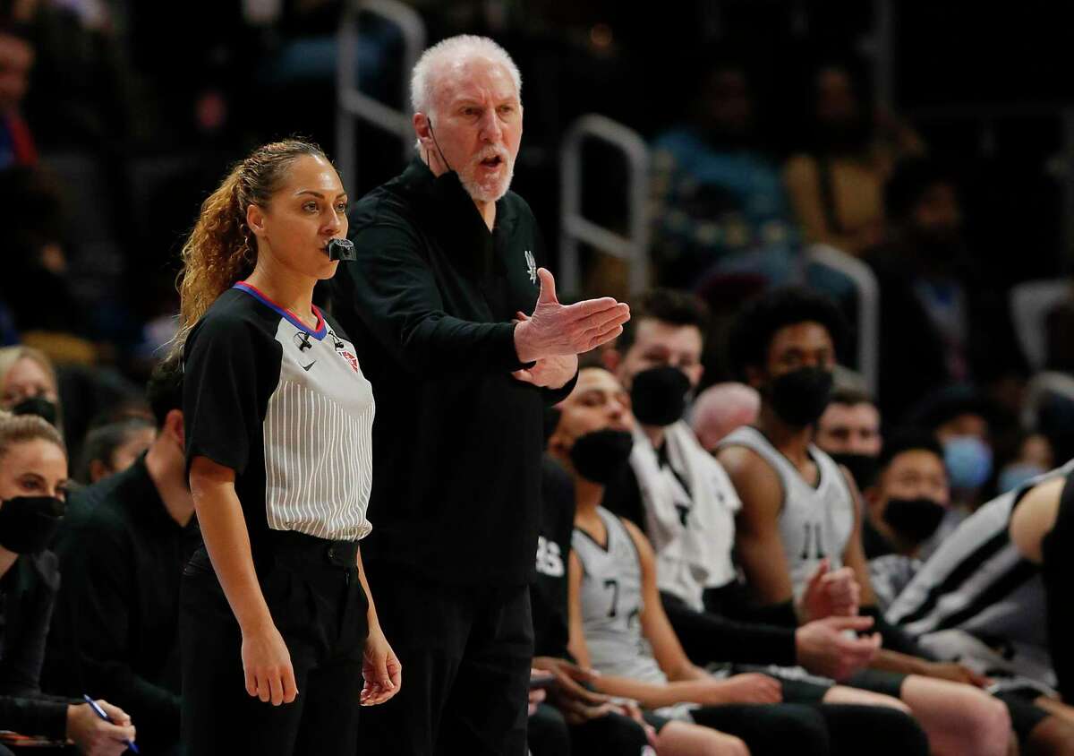 San Antonio Spurs head coach Gregg Popovich complains to NBA referee Sha'Rae Mitchell during the second half of an NBA basketball game against the Detroit Pistons Saturday, Jan. 1, 2022, in Detroit. (AP Photo/Duane Burleson)