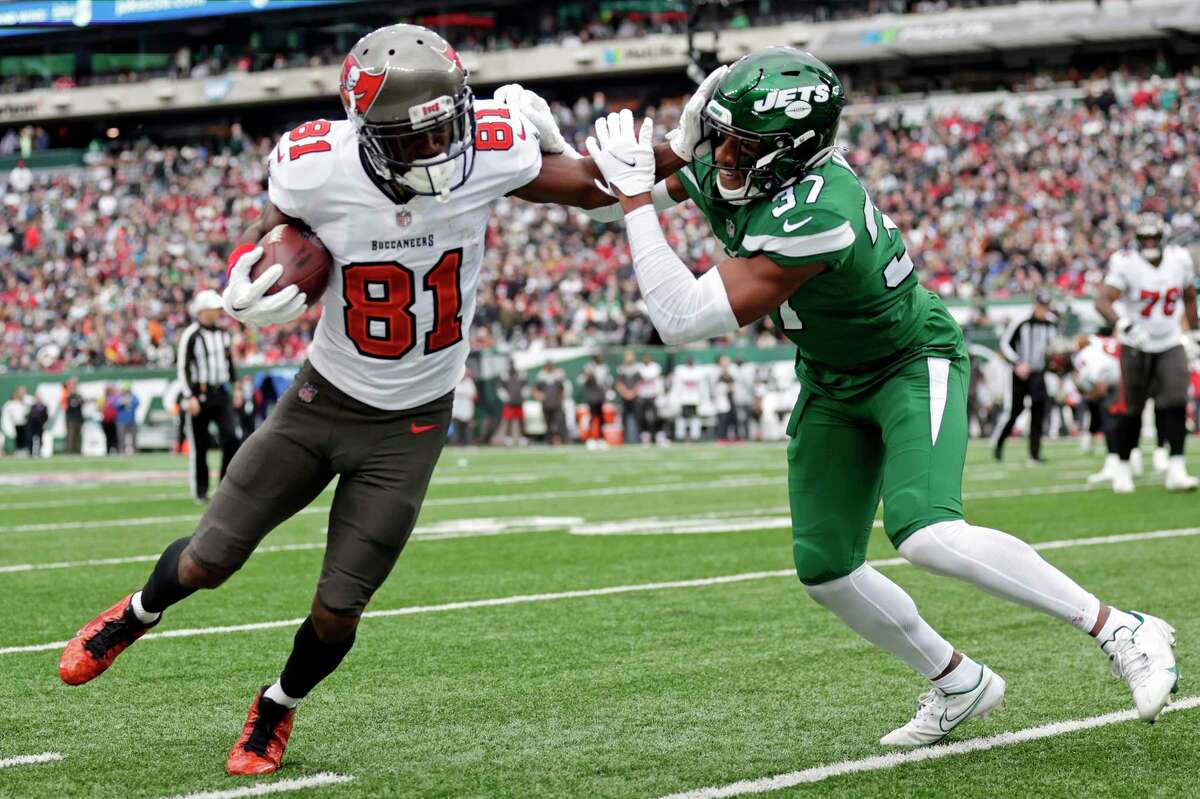 New York Jets cornerback Bryce Hall (37) tackles Tampa Bay Buccaneers wide receiver Antonio Brown (81) during an NFL football game, Sunday, Jan. 2, 2022, in East Rutherford, N.J. (AP Photo/Adam Hunger)