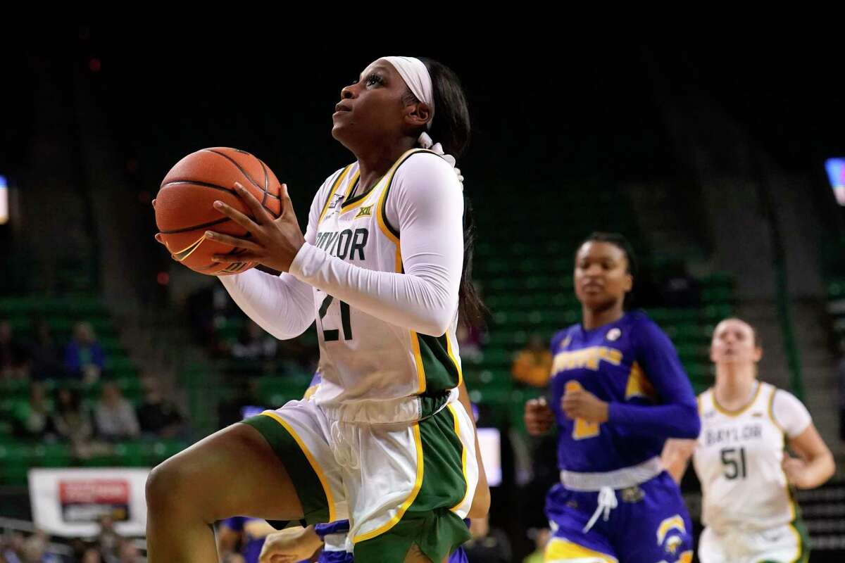Baylor guard Ja'Mee Asberry (21) goes to the basket for a shot as Morehead State's Jada Claude, rear, watches during the second half of an NCAA college basketball game in Waco, Texas, Tuesday, Nov. 30, 2021. (AP Photo/Tony Gutierrez)