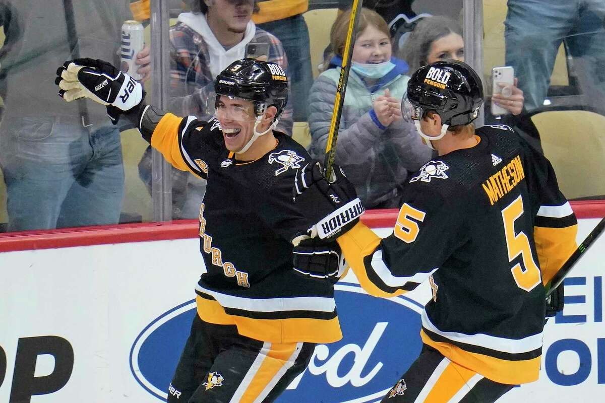 Pittsburgh Penguins' Evan Rodrigues (9) celebrates his second goal of the first period of an NHL hockey game against the San Jose Sharks in Pittsburgh, Sunday, Jan. 2, 2022. (AP Photo/Gene J. Puskar)