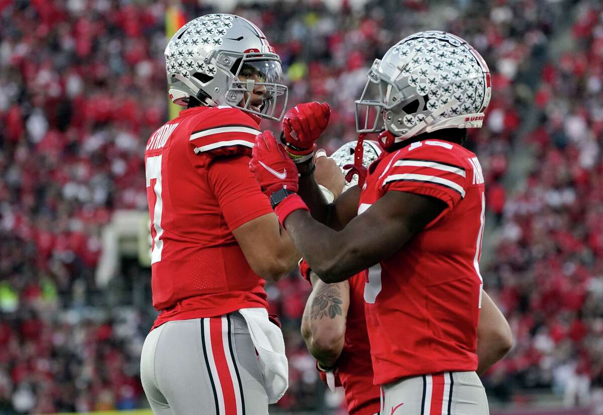 Ohio State’s C.J. Stroud (left) passed for a school-record 573 yards — 347 of them to Jaxon Smith-Njigba (right) — in Pasadena.