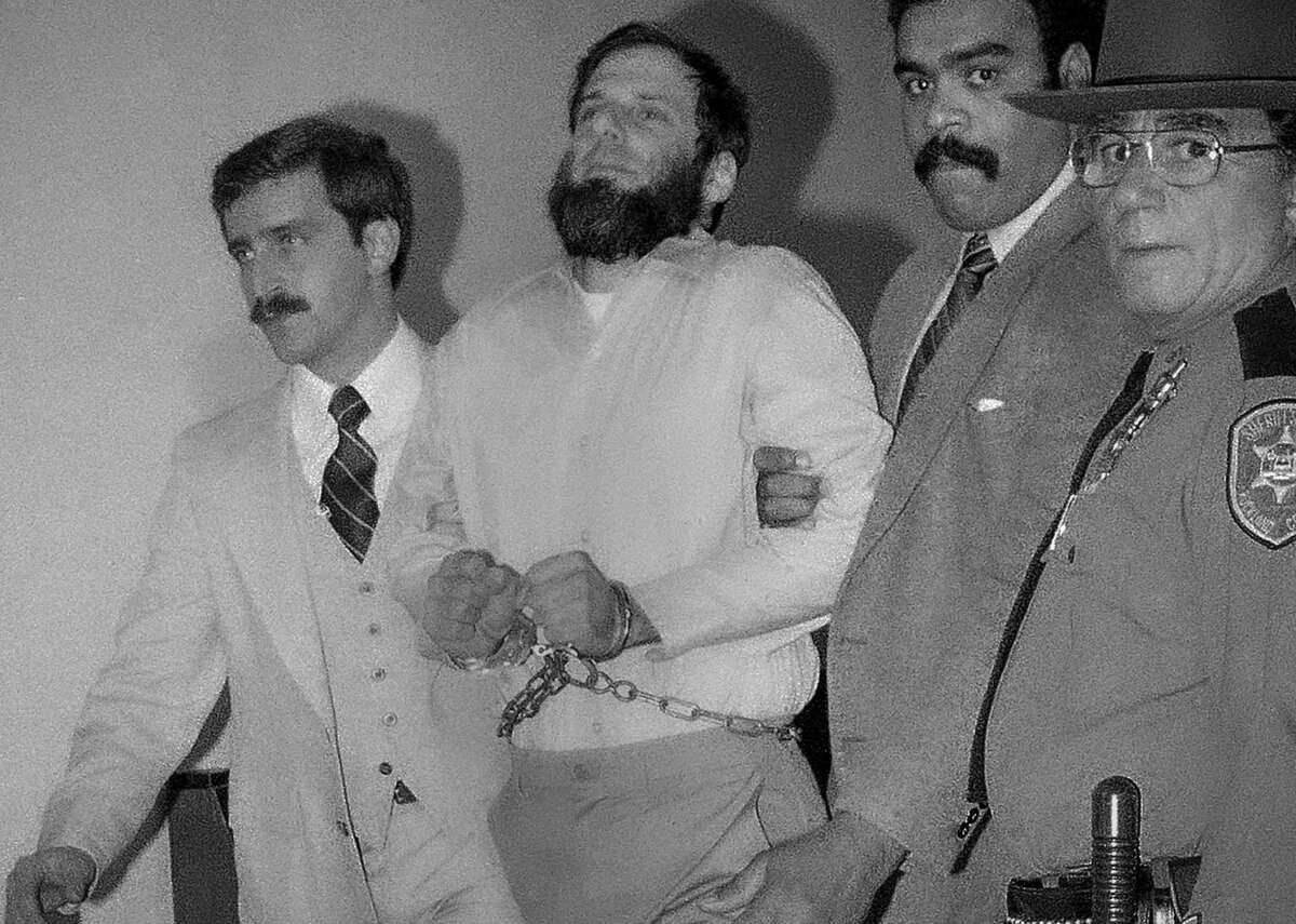 Law officials escort a handcuffed David Gilbert, second from left, from the Rockland County Court in New City, New York, on Nov. 23, 1981. Gilbert, a former Weather Underground member, described his path from nonviolent 1960s activist to would-be revolutionary during a 4 1/2-hour hearing before the New York state parole board panel that approved his parole in October, 40 years after he served as a getaway driver in the botched Brink's robbery that left three men dead and several others wounded.