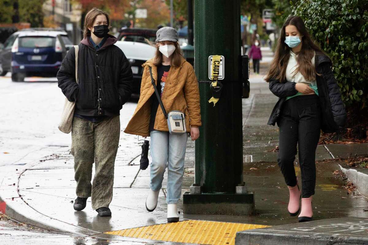 Widespread COVID vaccinations, immunity and safety precautions, such as masks on this group on College Avenue in Oakland, instill hope in medical experts battling the pandemic.
