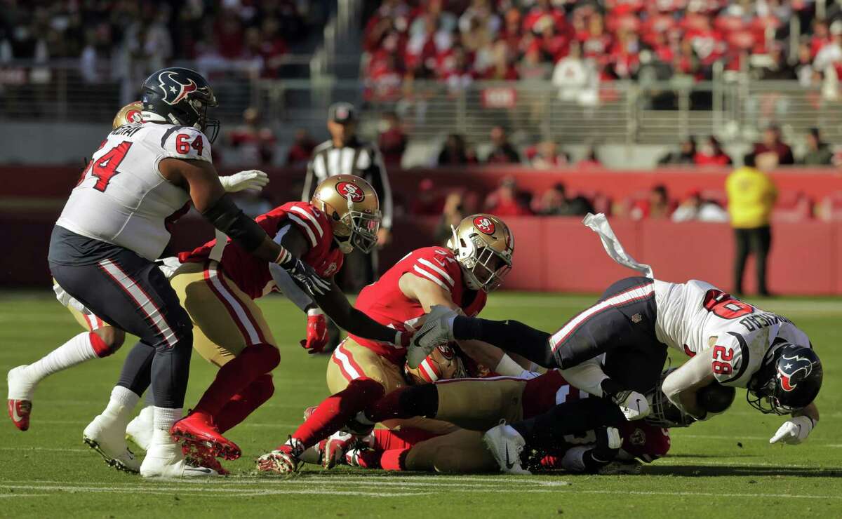 49ers defense stops Rex Burkhead (28) from a first down in the first half as the San Francisco 49ers played the Houston Texans at Levi’s Stadium in Santa Clara, Calif., on Sunday, January 2, 2022.