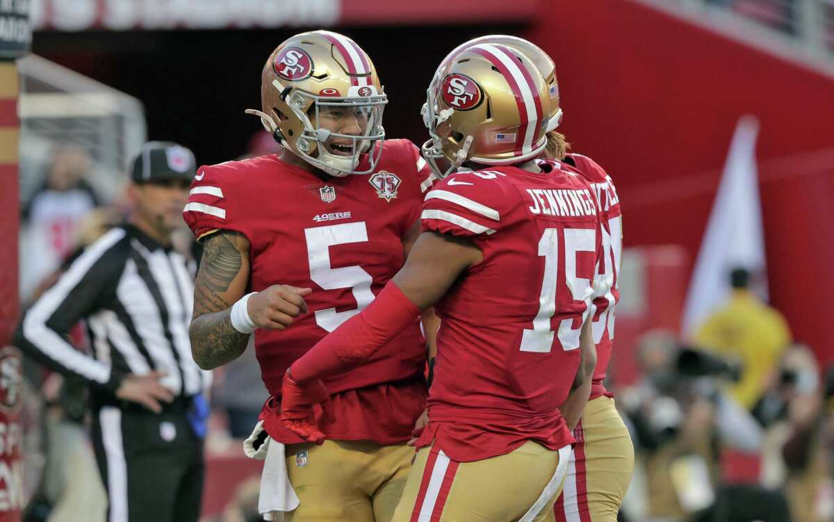 Trey Lance (5) and Juaun Jennings (15) and George Kittle (85) celebrate Lance’s rushing touchdown before it was called back on a penalty late in the second half as the San Francisco 49ers played the Houston Texans at Levi’s Stadium in Santa Clara, Calif., on Sunday, January 2, 2022.