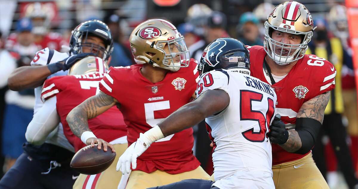 San Francisco 49ers quarterback Trey Lance (5) passes as he is pressured by Houston Texans defensive end Jordan Jenkins (50) during the fourth quarter of an NFL football game Sunday, Jan. 2, 2022, in Santa Clara, Calif.