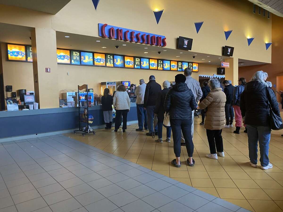 Patrons of the Regal Branford theater line up at the concession stand on Tuesday afternoon. The theater is closing permanently on Jan. 2, employees said Tuesday.