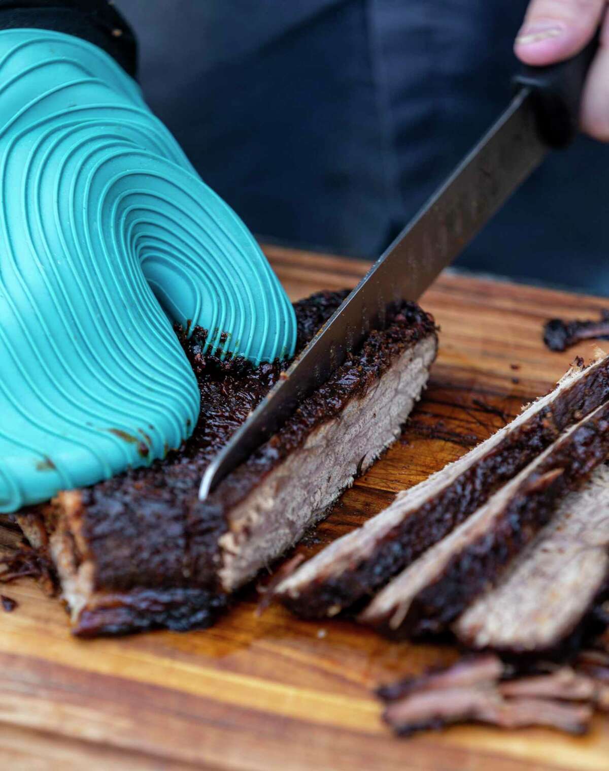 Brisket cooked in the oven gets sliced at Chuck’s Food Shack.