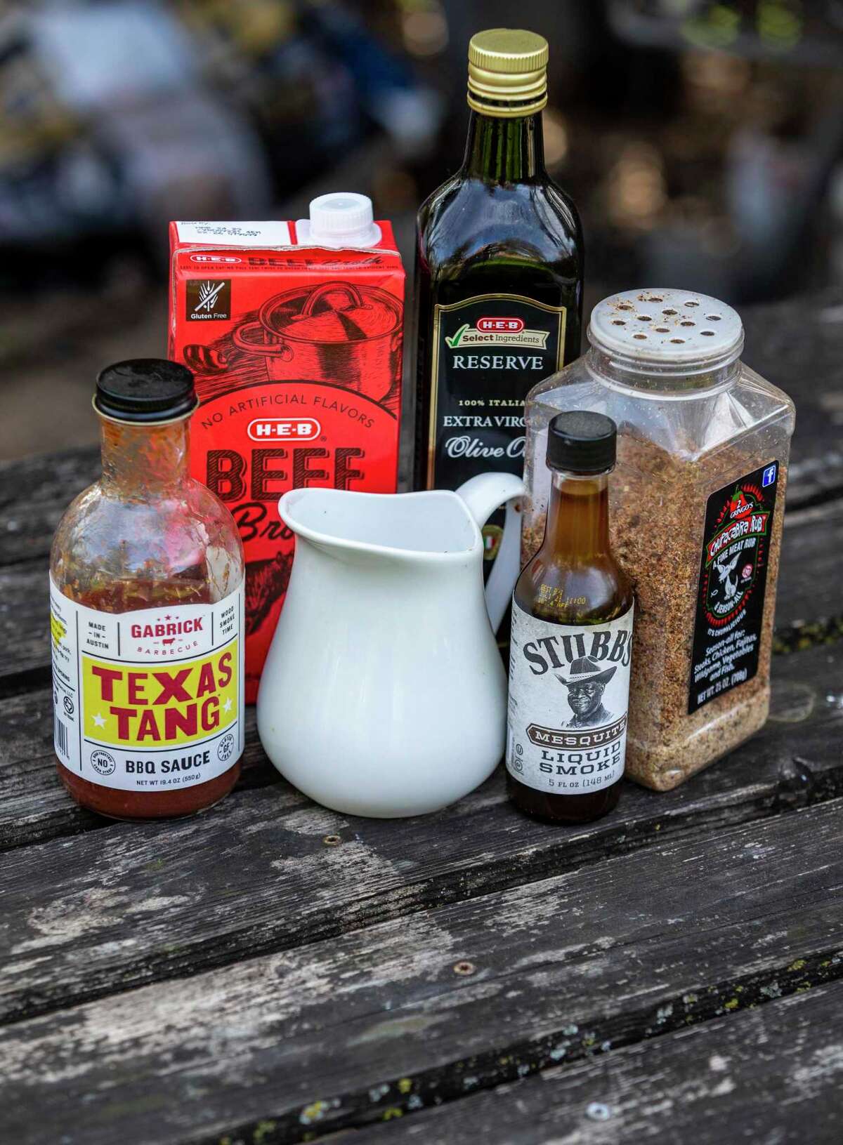 The ingredients used to cook a brisket in the oven include barbecue sauce, beef broth, salt, olive oil, liquid smoke, and barbecue sauce.