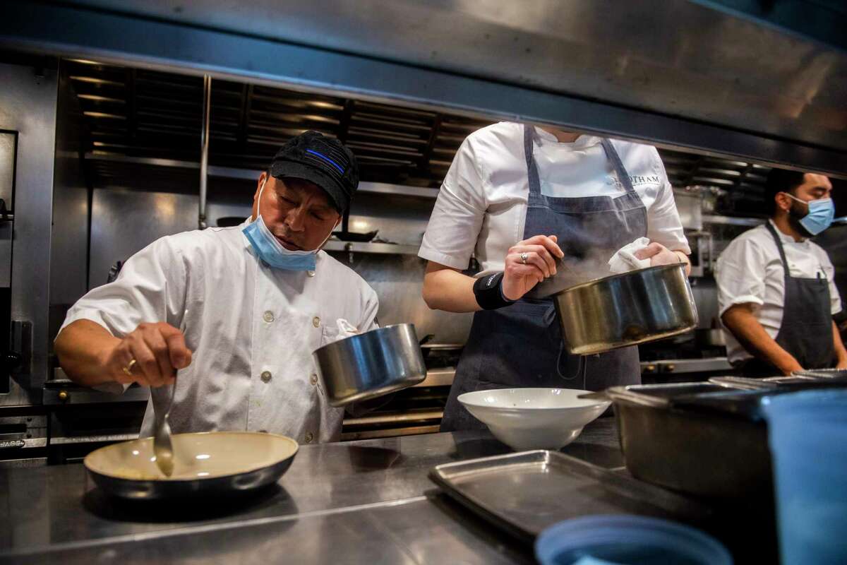 Workers in a kitchen in New York City. A reader says President Joe Biden does not get the credit he deserves for a strong economic rebound.