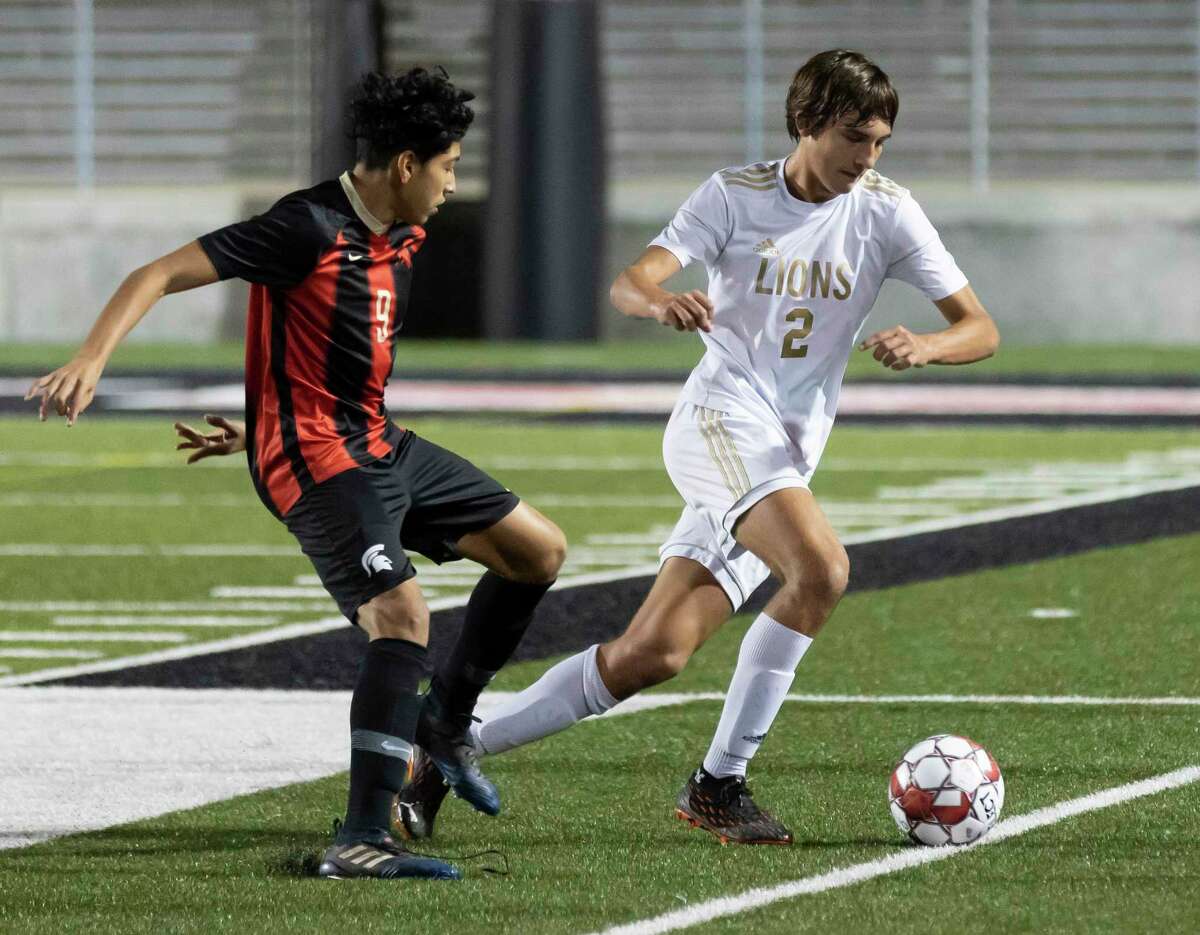 Lake Creek Hunter Robert (2) steals control of the ball from Porter Abalardo Lopez (8) during the first half of a District 20-5A boys soccer at Randall Reed Stadium, Friday, March 5, 2021, in New Caney.