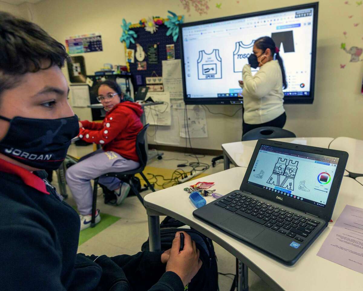Student Isaiah Sandoval, left, listens to teacher Cheryll Toscano, right, Monday, Jan. 3, 2022 as she talks about logo design with some of her 6th grade students during an intersession class at Hawthorne Academy.