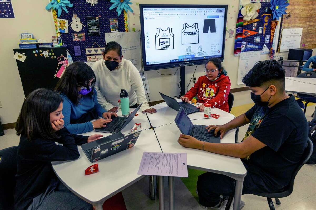 Teacher Cheryll Toscano talks Monday, Jan. 3, 2022 with some of her 6th grade students during an intersession class at Hawthorne Academy.