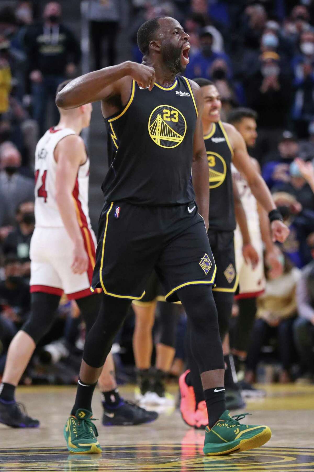 Golden State Warriors' Draymond Green celebrates a Jordan Poole dunk in 4th quarter during Warriors' 115-108 win over Miami Heat in NBA game at Chase Center in San Francisco, Calif., on Monday, January 3, 2022.