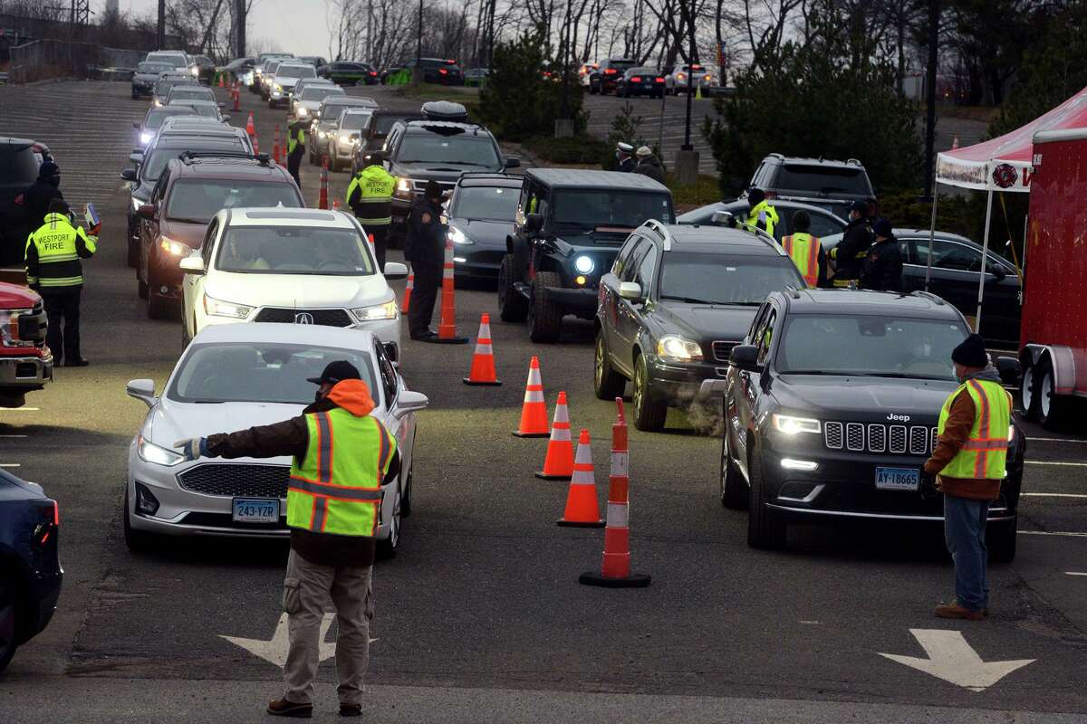 The drive-thru COVID-19 home test kits distribution in the parking lot of the Greens Farms train station, in Westport, Conn. Jan. 3, 2021.