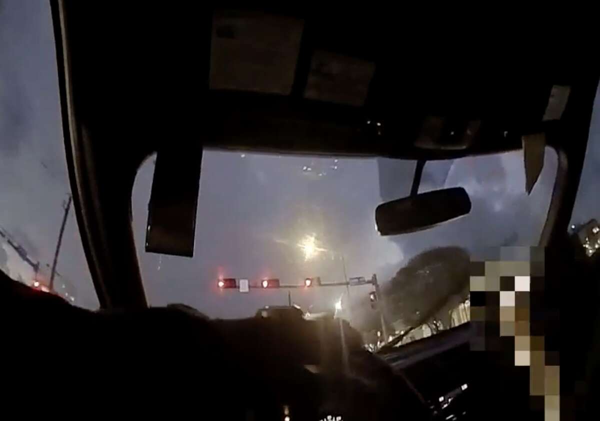In this still from police body-camera footage, Houston police officer Orlando Hernandez drives through a red light at Reed Road and Cullen Boulevard moments before careening onto the sidewalk and killing 62-year-old Michael Wayne Jackson on Saturday, Dec. 4, 2021. 