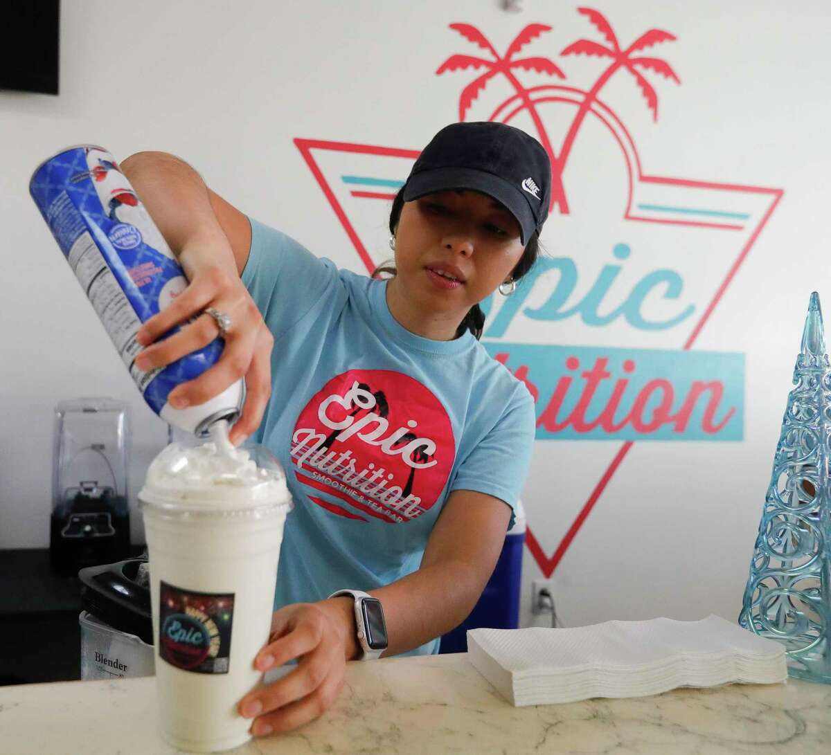 Diana Hernandez works on a shake at Epic Nutrition, Tuesday, Jan. 4, 2022, in Conroe. Hernandez and her husband, Jose Ramirez, opened their storefront along North Loop 336 a year ago serving detox and beauty teas, as well as pre-workout and protein coffees.