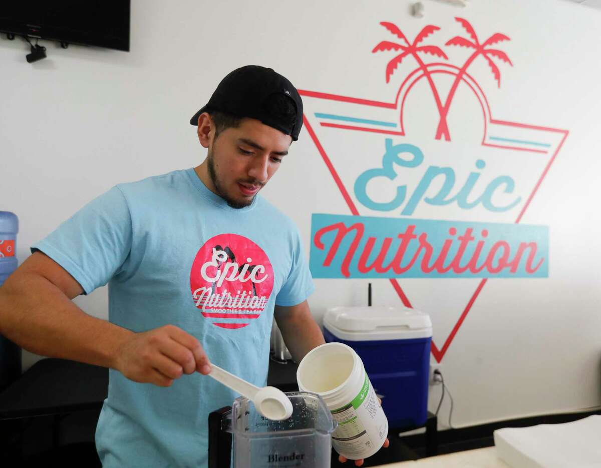 Jose Ramirez makes a protein shake at Epic Nutrition, Tuesday, Jan. 4, 2022, in Conroe. Ramirez and his wife, Diana Hernandez, opened their storefront along North Loop 336 a year ago serving detox and beauty teas, as well as pre-workout and protein coffees.