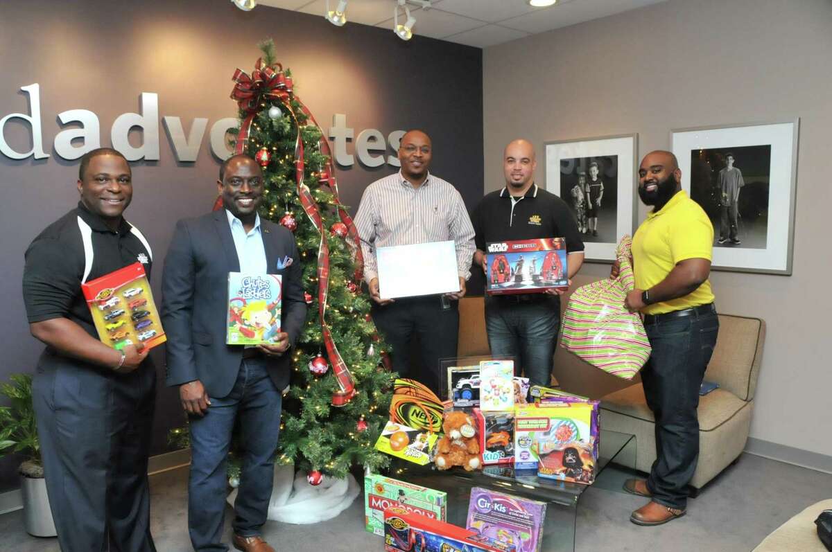 100 Black Men of Metropolitan Houston members provide toys to Child Advocates.