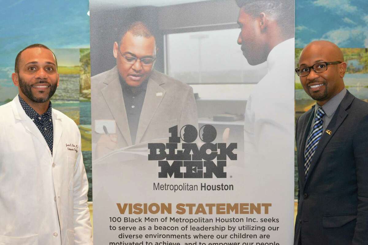 100 Black Men of Metropolitan Houston President Dr. Justin Washington (right).