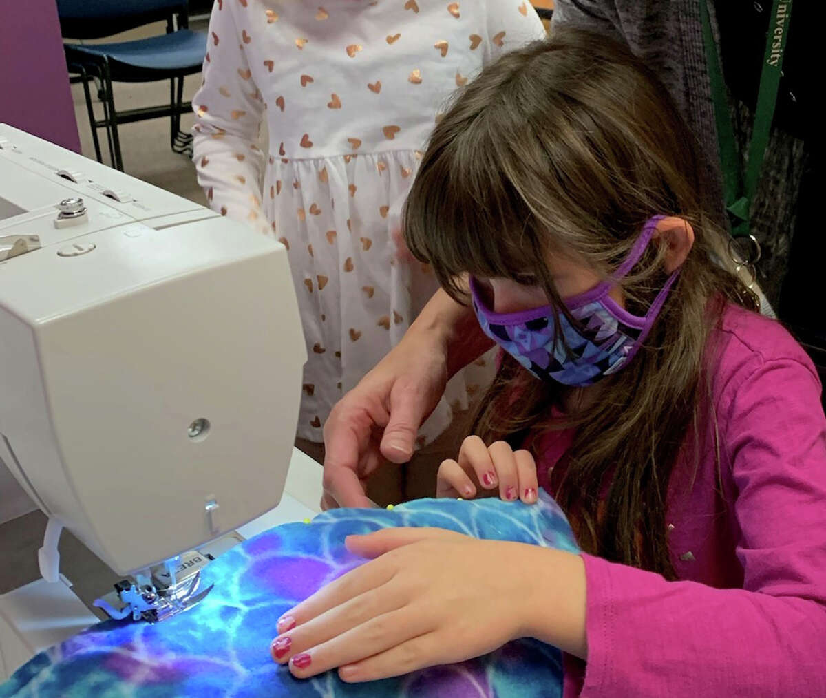 Kaelyn Williams (6) learns to sew during a recent Lake County 4-H sewing class. 