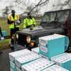 Residents receive free at-home COVID-19 test kits at a distribution site on January 02, 2022 in Stamford, Connecticut. The Connecticut state government received some 400,000 tests over the weekend which were sent to cities and towns for local distribution.