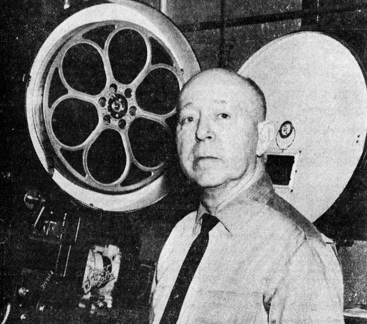 Arthur “Shorty” Bureau, Sr. is shown near one of the two huge movie projectors at the Vogue Theatre where he has been the projectionist since the Vogue went into operation in January 1938. The veteran projectionist ended 53 years of employment at local theater last Saturday. The photo was published in the News Advocate on Jan. 5, 1962.