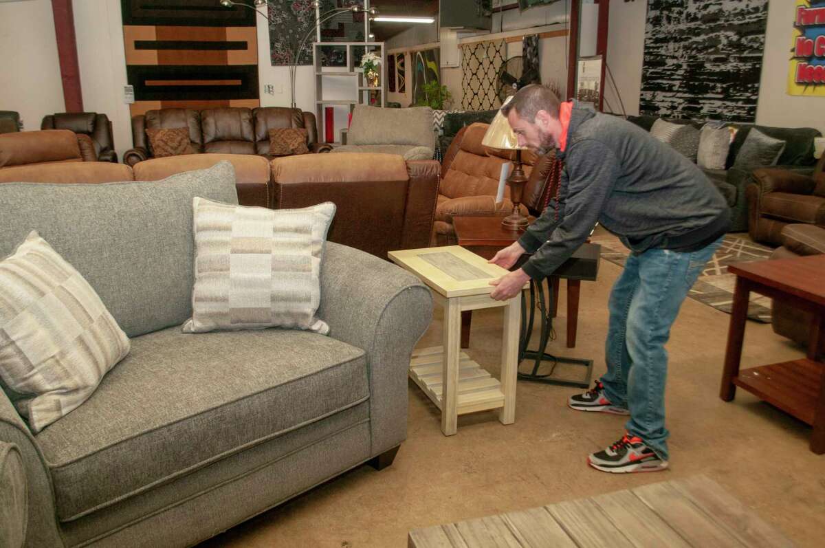 Kenny Miller, vice president of operations for Billy's Furniture, rearranges a display at the company's Jacksonville location at 617 E. Independence Ave. Billy's Furniture is looking for a new location from which to serve the White Hall area after being unable to renew the lease at 308 Third Ave. N., which is owned by a California-based company. 