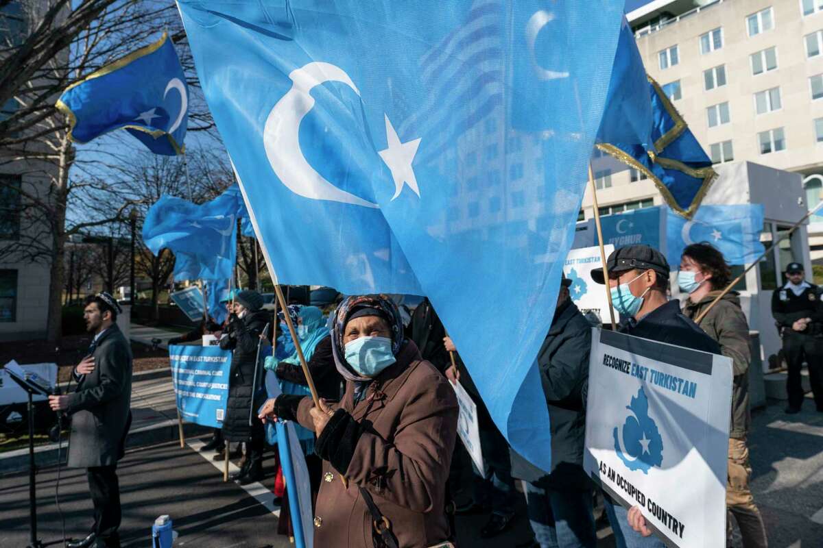Members of the East Turkistan National Awakening Movement protest China's treatment of Uyghurs, during a protest near the State Department, Wednesday, Dec. 22, 2021, in Washington.