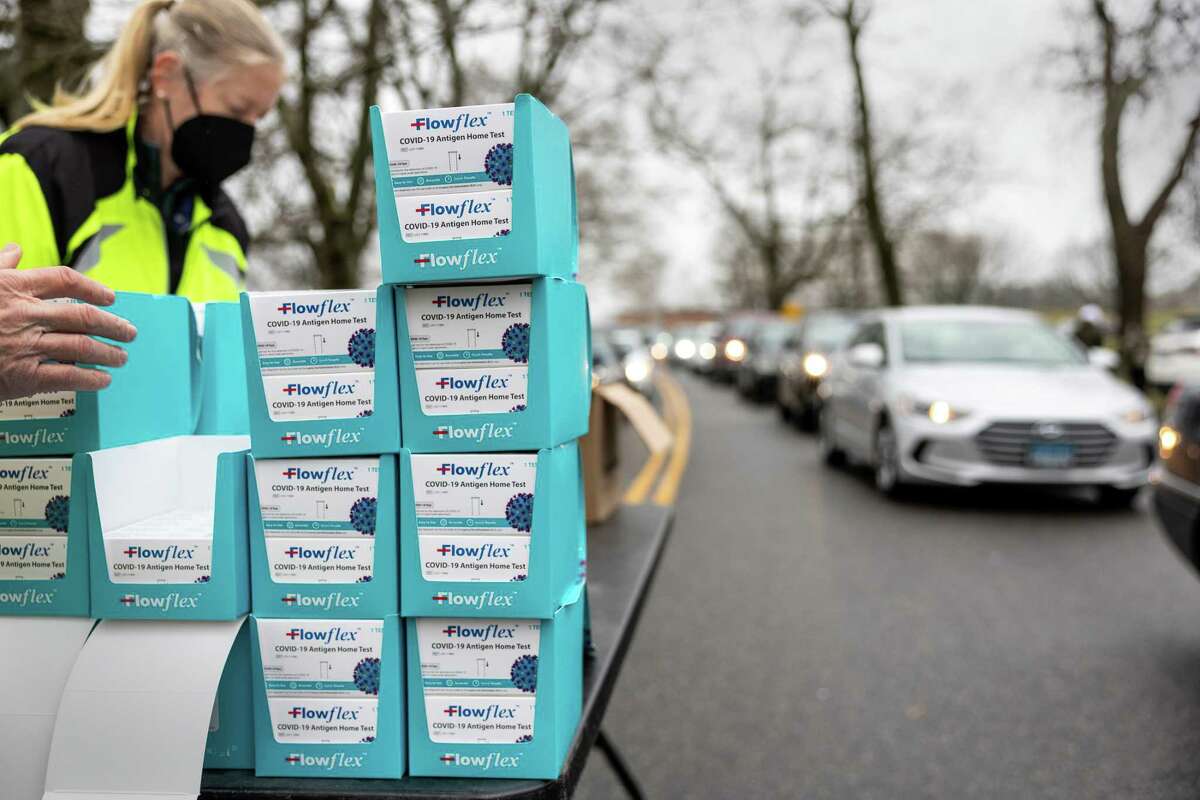 Residents line up at a drive-up distribution site to receive free at-home COVID-19 test kits on January 02, 2022 in Stamford, Connecticut.