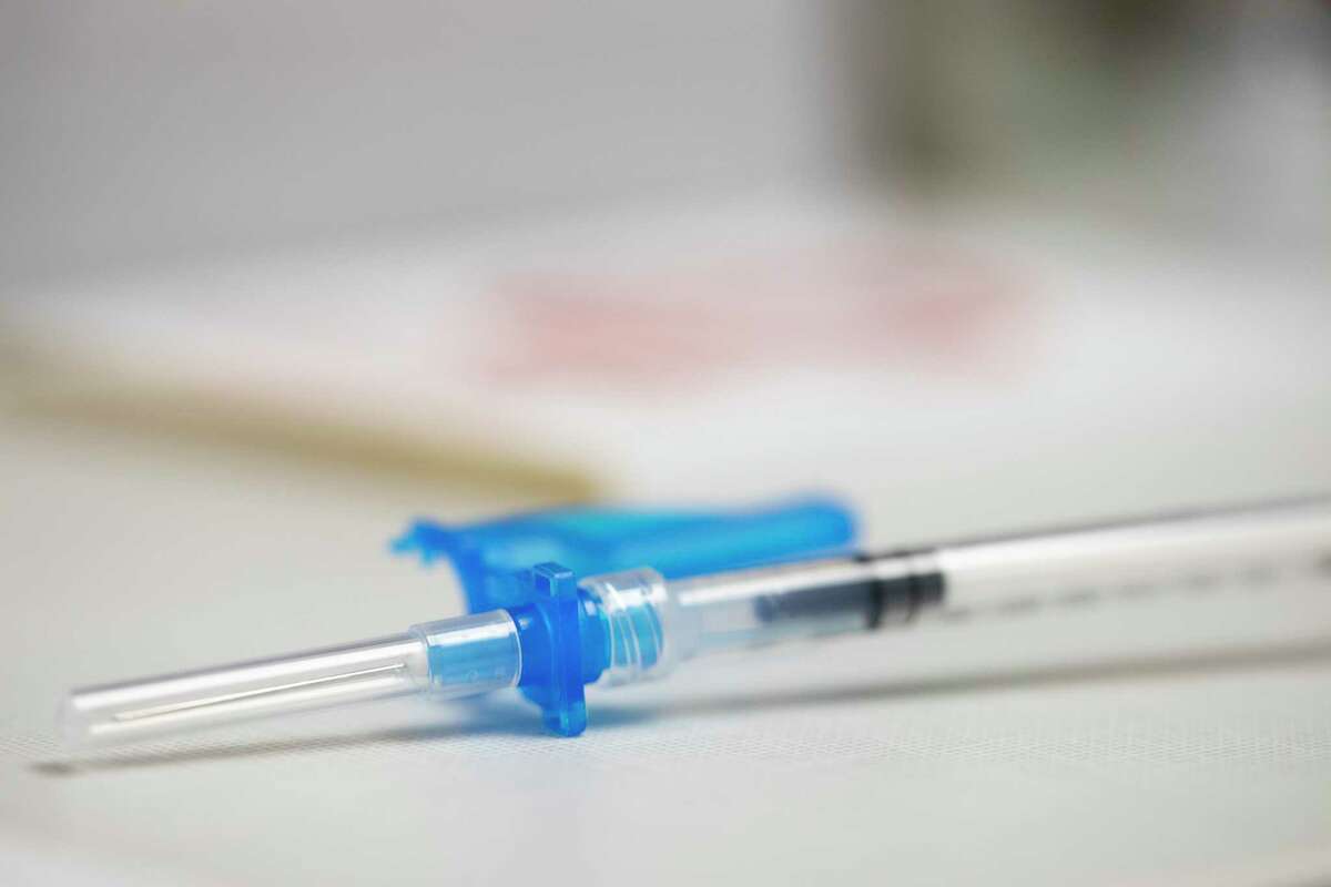 A syringe is prepped for a Moderna COVID-19 booster vaccine at a pharmacy in Portland, Ore., on Dec. 27. The Montgomery County Public Health District confirmed 5,091 new active cases Tuesday for a total of 9,547. The county’s total case count is now 100,677.