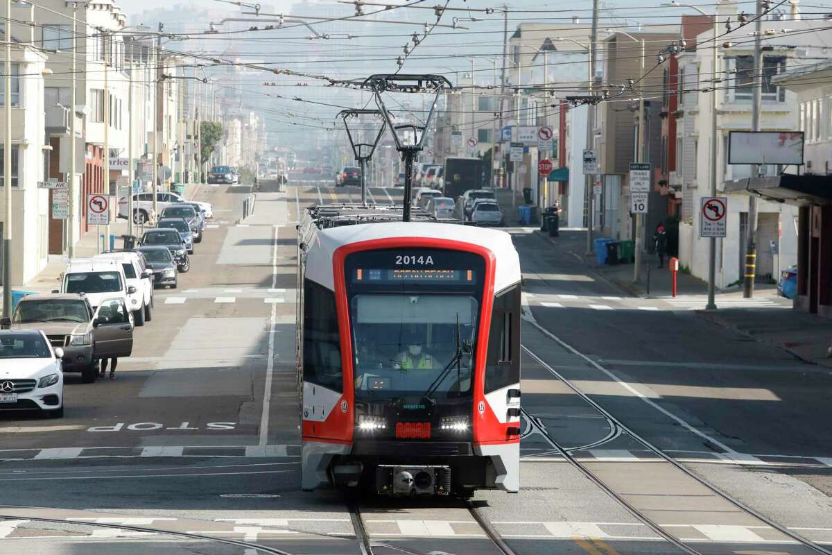 A Muni train is seen running on the N-Judah line in December. The omicron variant is sending swaths of city employees into quarantine, stressing services like Muni operation.