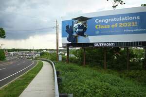 A billboard congratulates University of New Haven graduates on Rt. 1 South looking toward new development in the Allingtown section of West Haven on May 17, 2021.