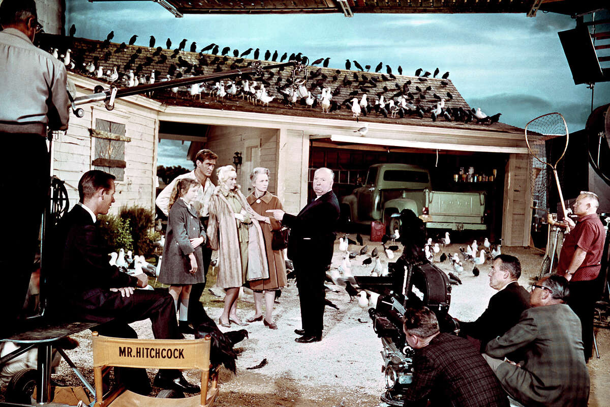 Veronica Cartwright, Rod Taylor, Tippi Hedren and Jessica Tandy with director and producer Alfred Hitchcock on the set of "The Birds."