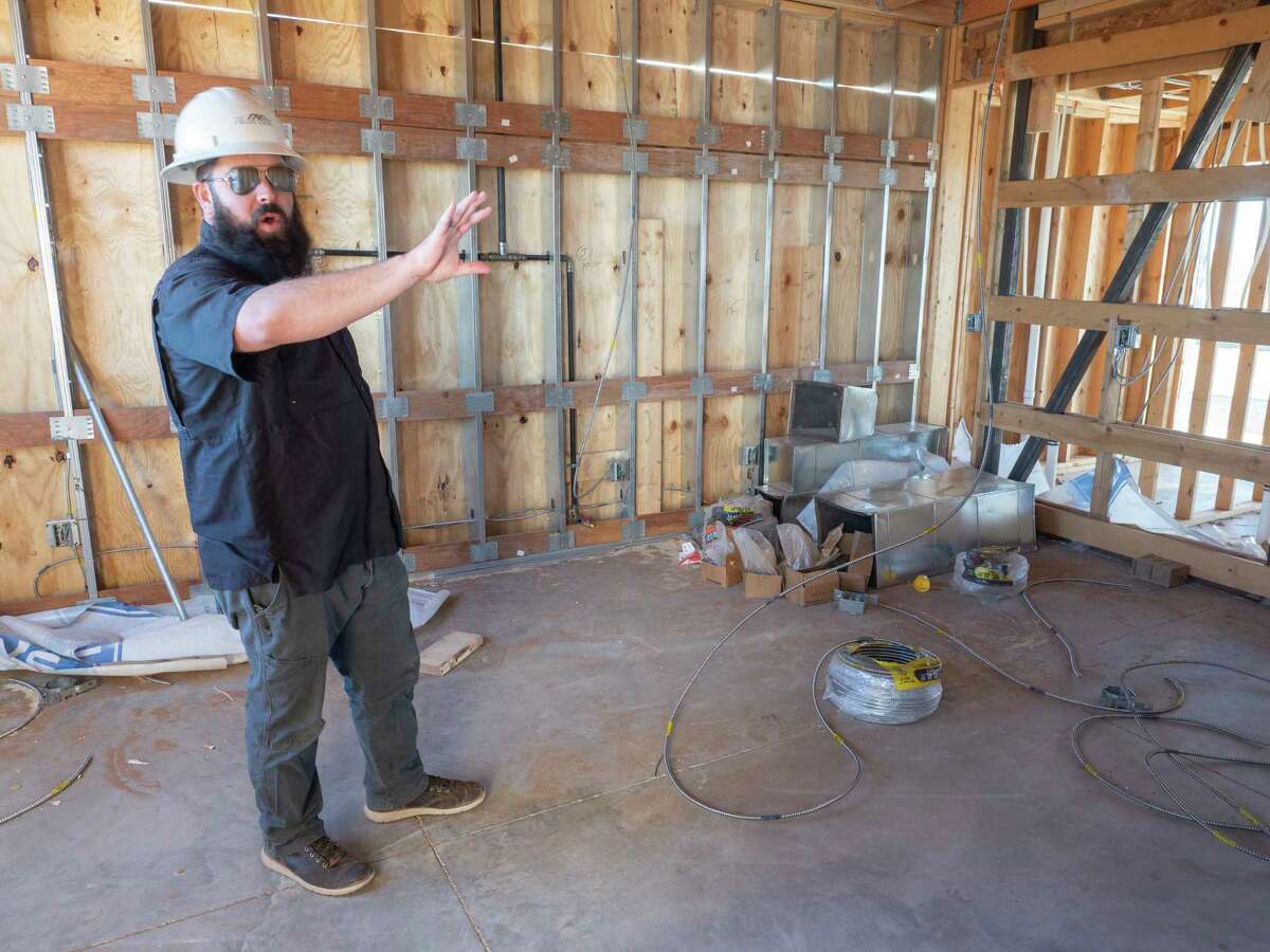 John-Mark Echols describes where the community kitchen with personal lockers for spices and supplies will be as work continues at The Field's Edge community area 01/04/2022 off Cholla Road in SW Midland. Tim Fischer/Reporter-Telegram