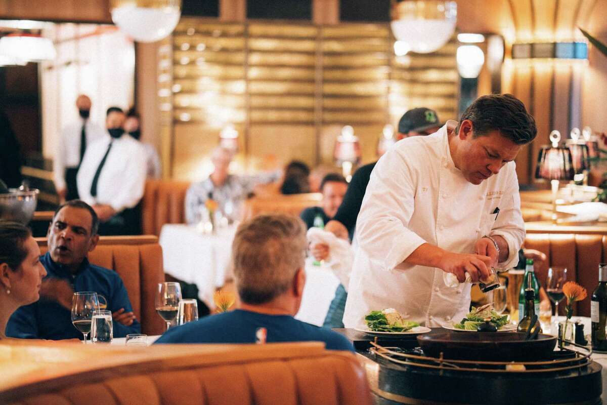 Tyler Florence makes Caesar salad on a tableside cart at Miller & Lux in San Francisco.
