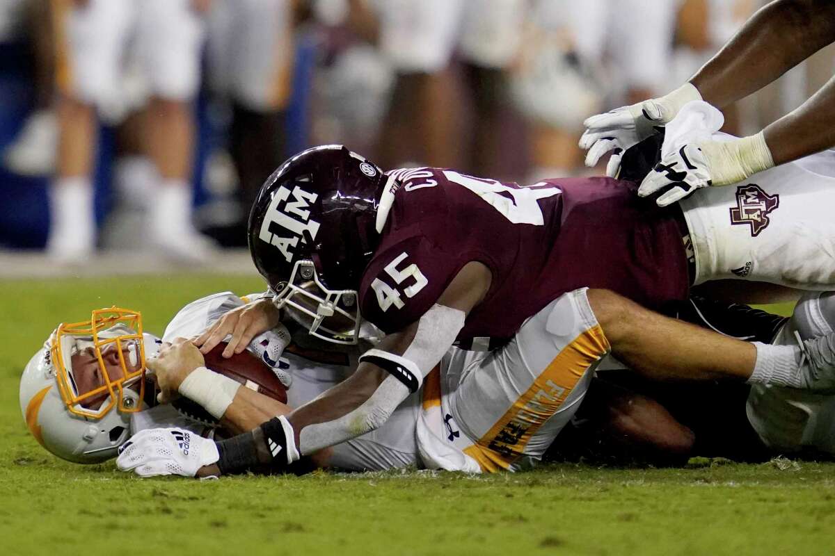 Texas A&M linebacker Edgerrin Cooper (45), here sacking Kent State quarterback Dustin Crum in September, was part of a unit that was 14th in the nation in total defense in 2021.