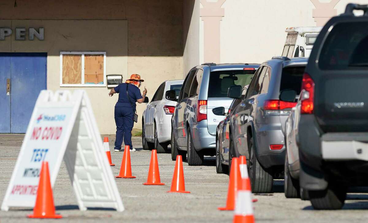 People wait at a Heal 360 drive through COVID testing site in a shopping center along Tomball Pkwy. near Bammel North North Houston Rd., Tuesday, Jan. 4, 2022 in Houston.