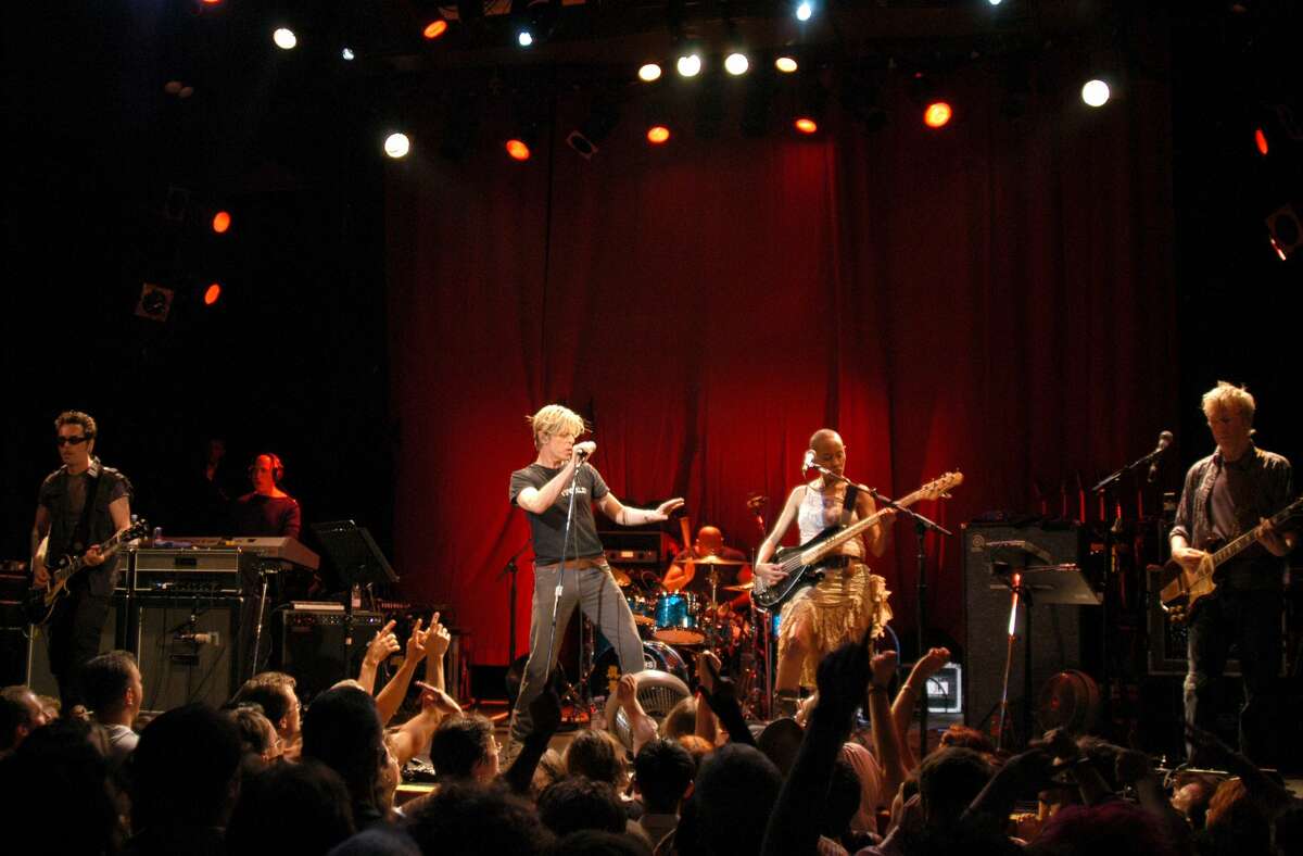 David Bowie (center) and bassist Gail Ann Dorsey (right of Bowie), who lives in Ulster County, perform in a special intimate show for hundreds of concertgoers at The Chance in Poughkeepsie on Aug. 19, 2003.