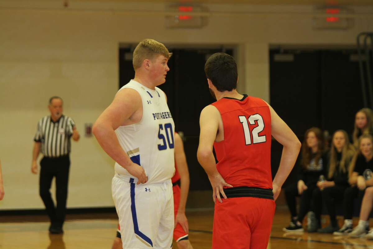 Onekama's Adam Domres and Bear Lake's Jake Griffis prepare to tip off. 