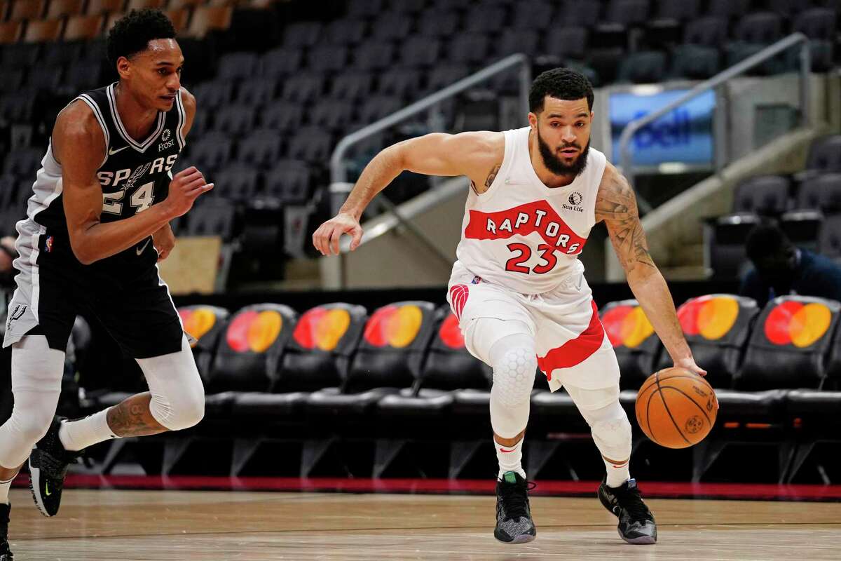 Raptors guard Fred VanVleet (23) drives past Spurs guard Devin Vassell (24) during the first half Tuesday, Jan. 4, 2022, in Toronto.