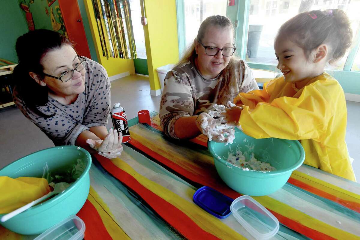 Leyla Kaman plays with mom Misty Kaman as Melissa Londenberg looks on (at left) during the Play Makers class at MAKE Creative Space Tuesday. Photo made Tuesday, January 4, 2022 Kim Brent/The Enterprise