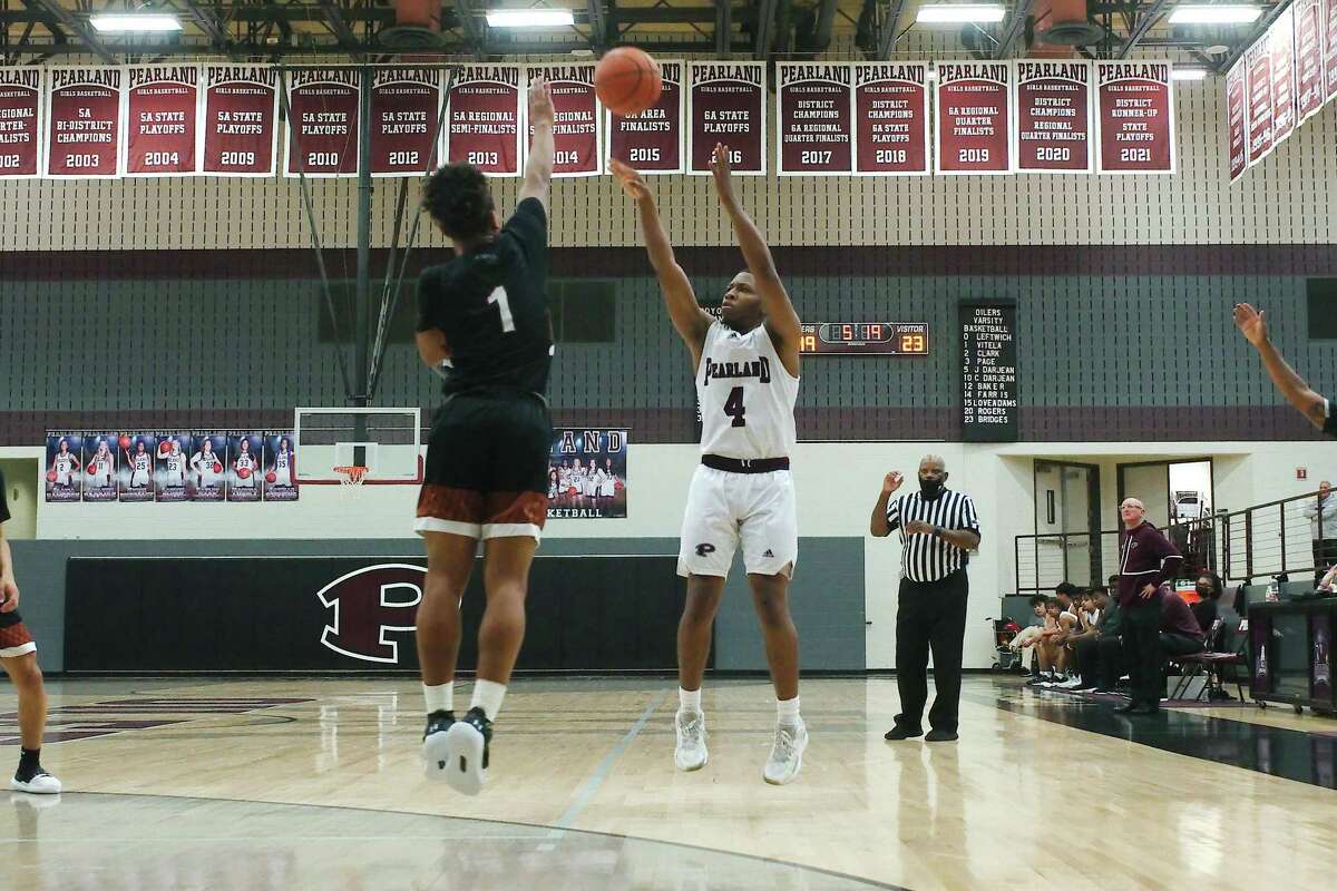 Pearland’s Charles Clark (4) launches a shot over Alvin’s Damon Gilford (1) Tuesday at Pearland High School.