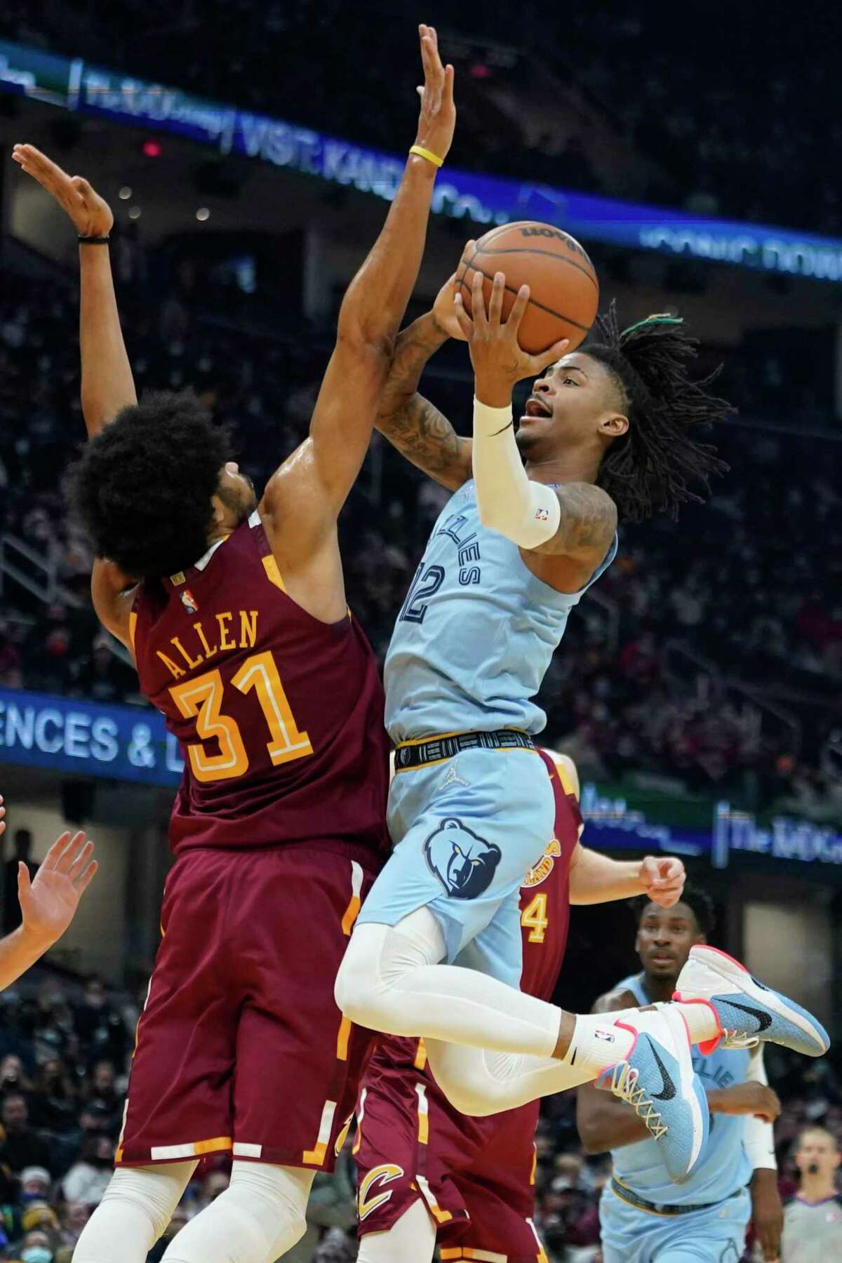 Memphis Grizzlies' Ja Morant (12) drives against Cleveland Cavaliers' Jarrett Allen (31) in the first half of an NBA basketball game, Tuesday, Jan. 4, 2022, in Cleveland. (AP Photo/Tony Dejak)