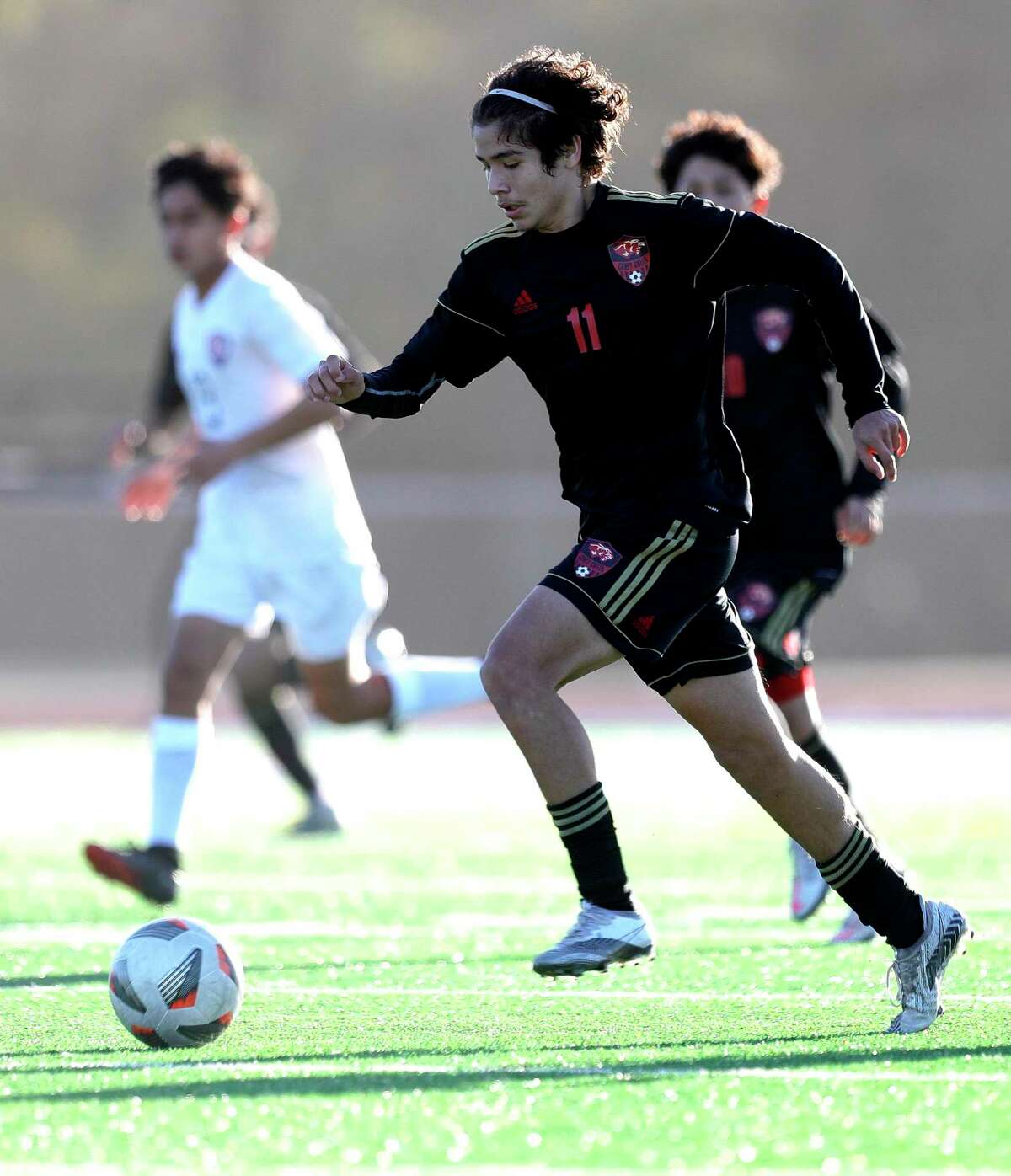 Caney Creek’s Jessy Villa (11) dribbles the ball in the first period of a soccer match during the Humble ISD Bayou City Classic at Kingwood High School, Friday, Jan. 15, 2021, in Kingwood.