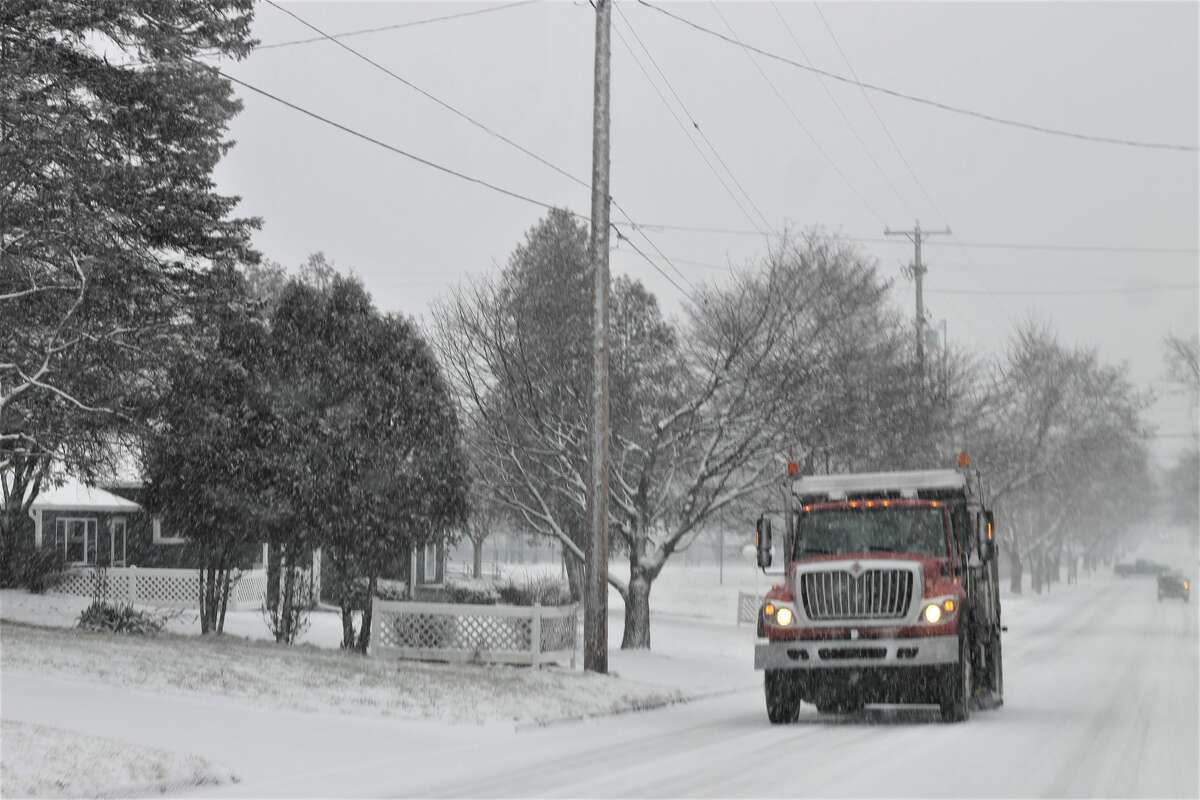A Manistee Department of Public Works truck salts Eighth Street on Wednesday morning.